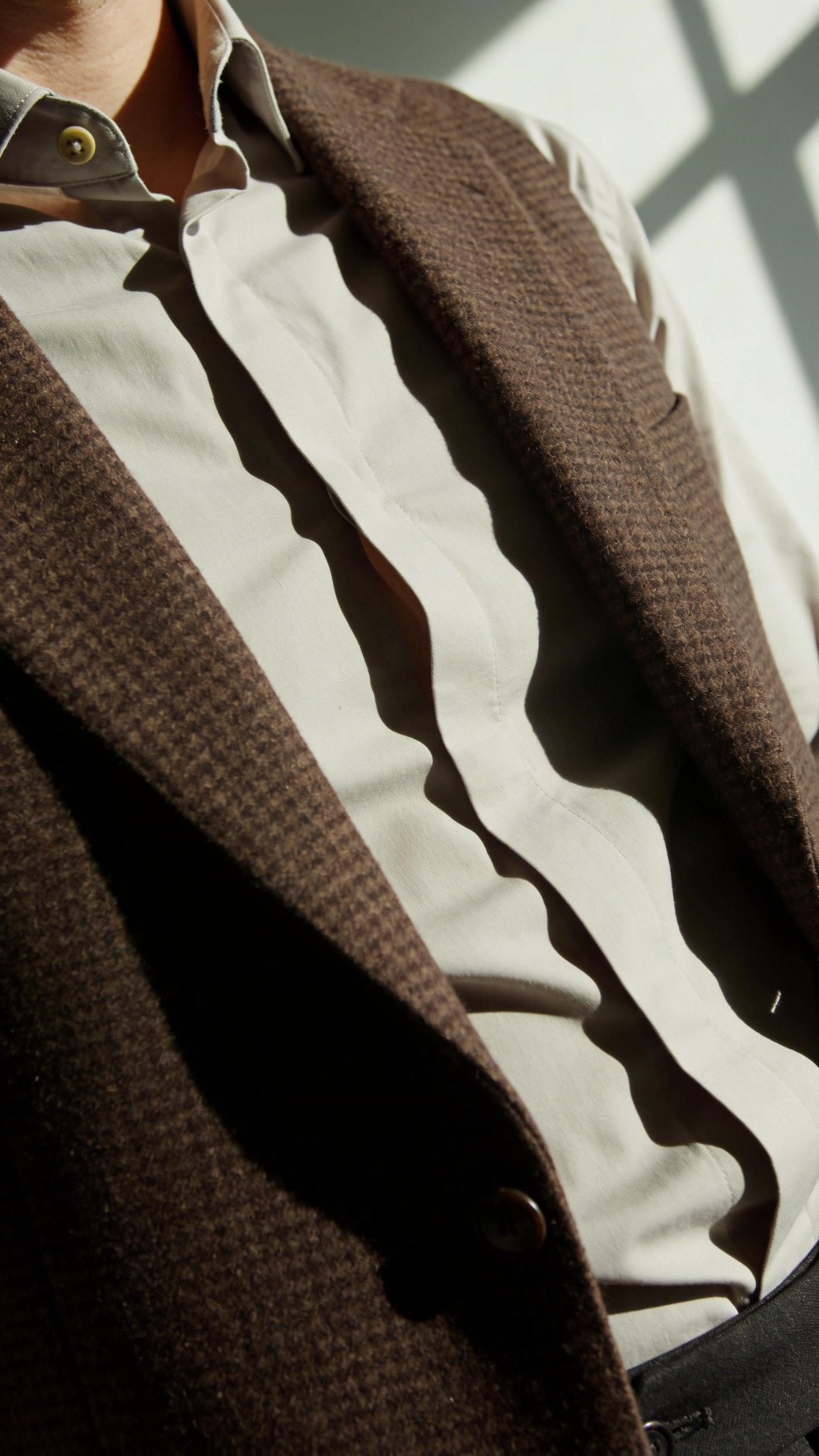 A snug wool waistcoat holding a shirt flat at the waist