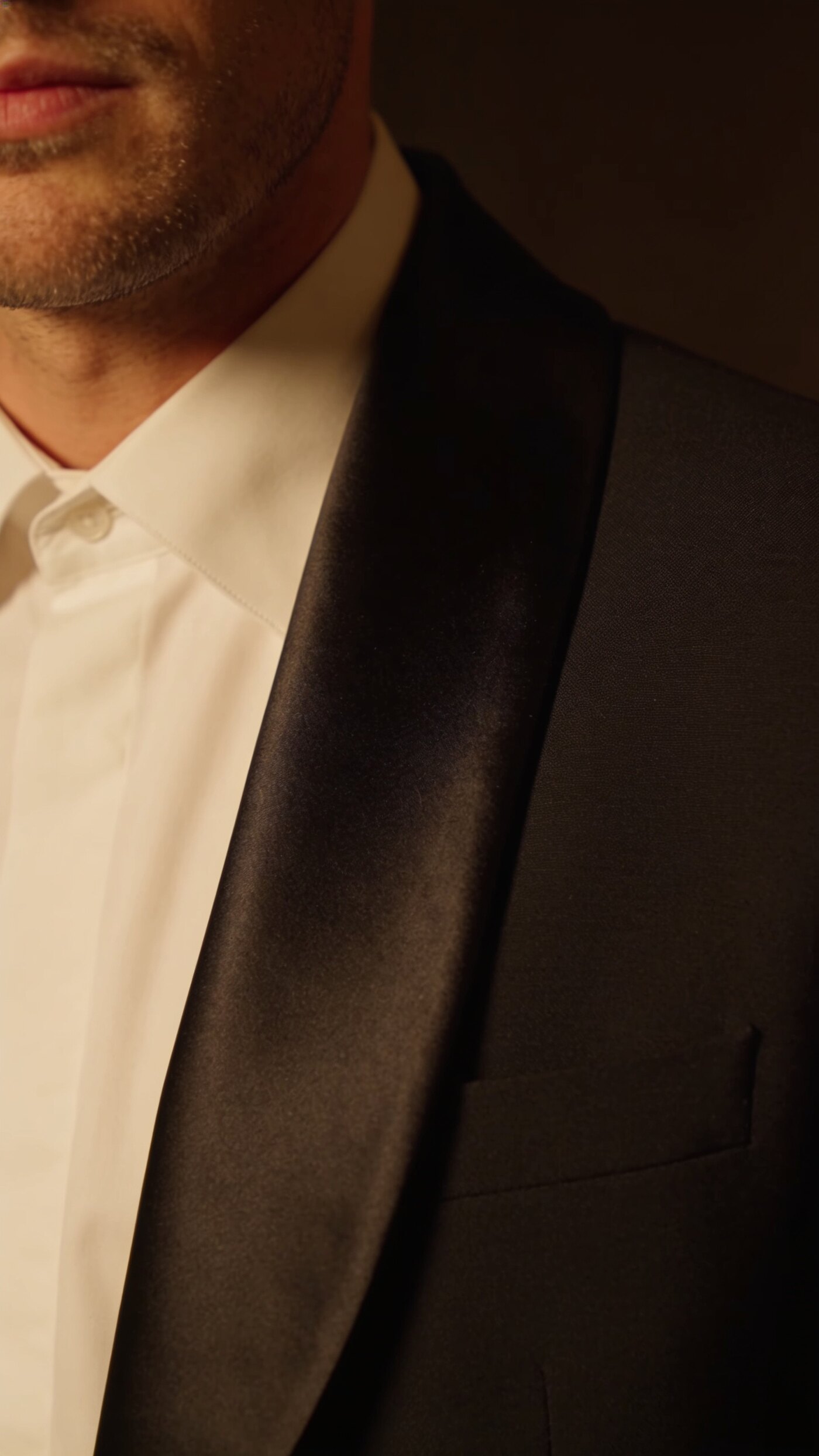 A midnight dinner jacket with an unbroken silk shawl lapel framing the shirt