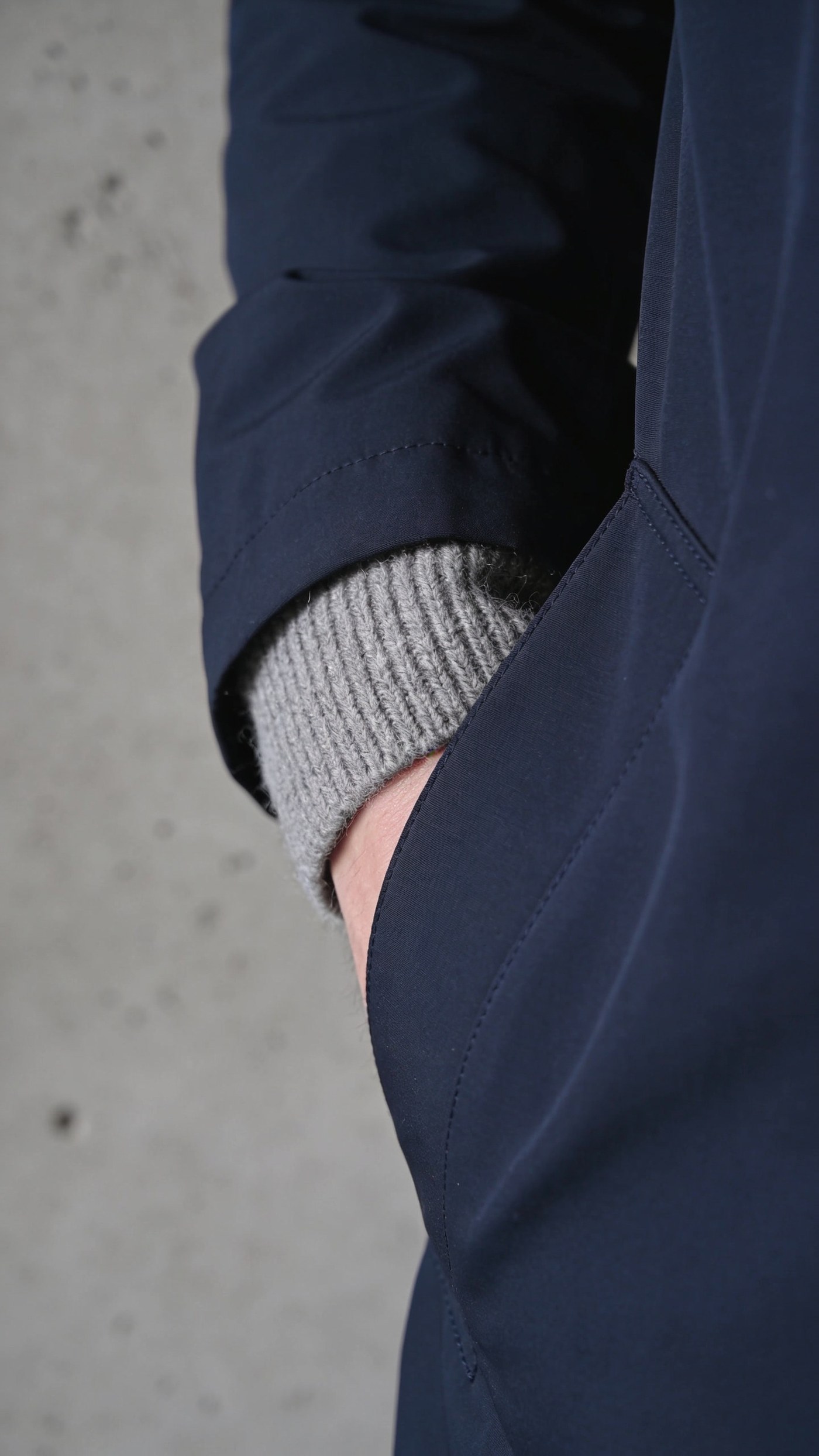 A matte cashmere jacket sleeve with no surface sheen under grey light